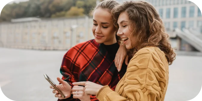 pretty-young-girls-checking-phone-together-scaled